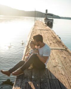 Man with girl at lake taking in the sights